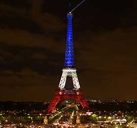 The Eiffel Tower illuminated with the colours of the French flag in the aftermath of the attacks