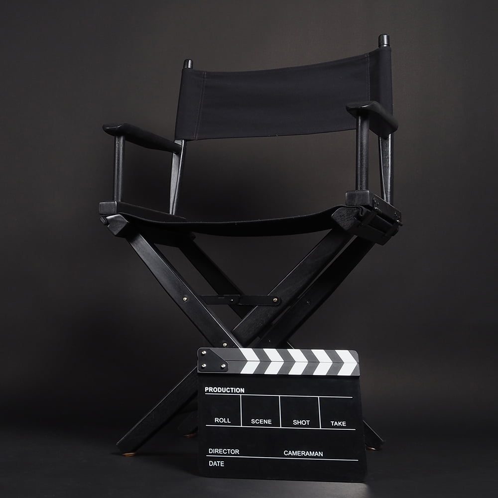 Clapperboard or movie slate with director chair use in video production or movie and cinema industry. It's black color.